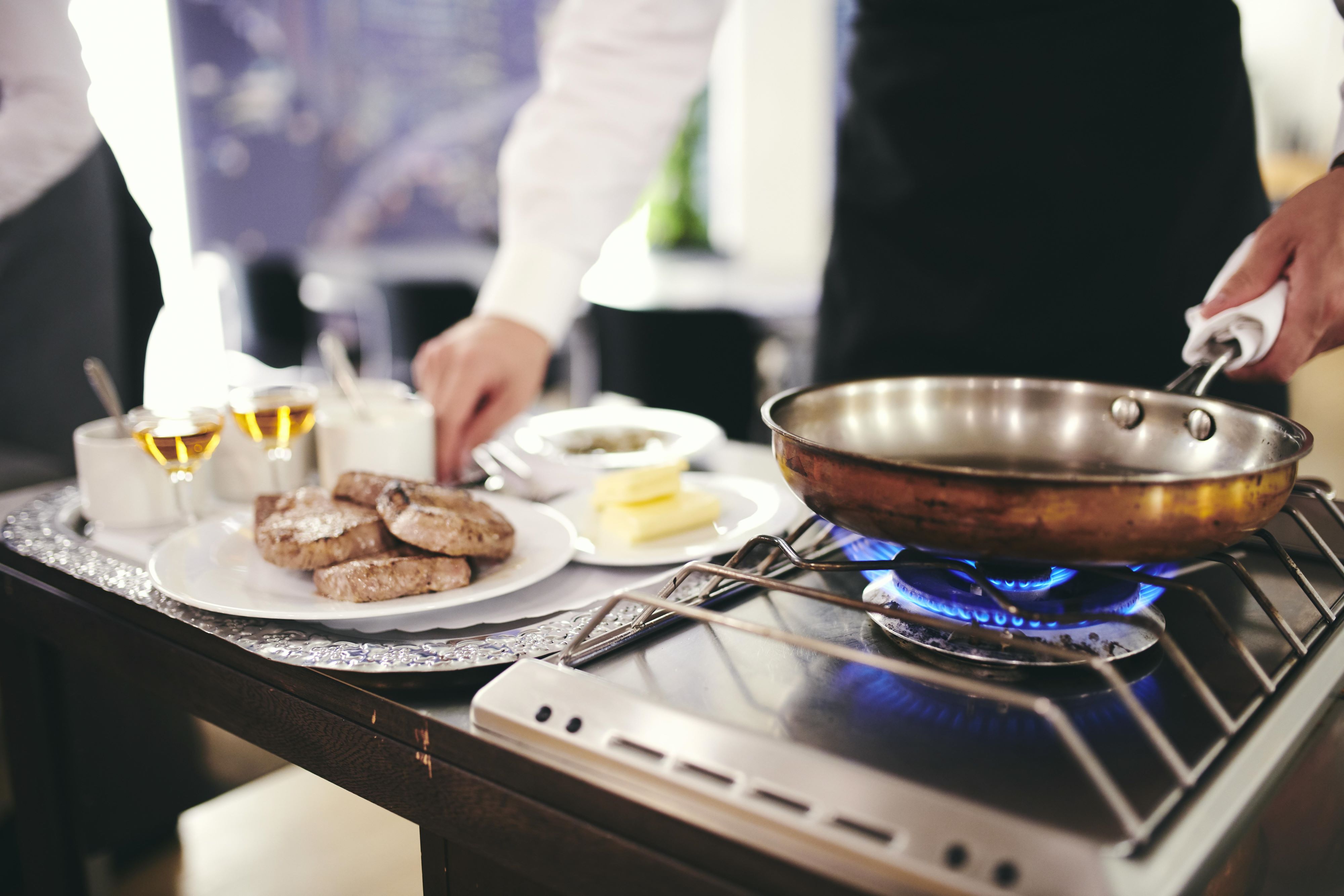 En tjenerelev gør klar til at flambere.